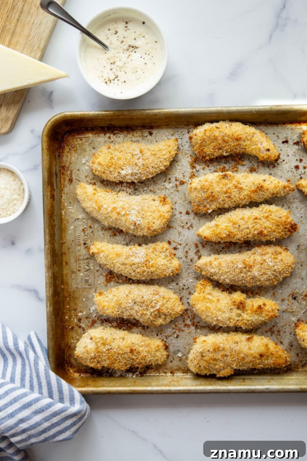 Close-up of crispy black pepper asiago chicken tenders ready to dip