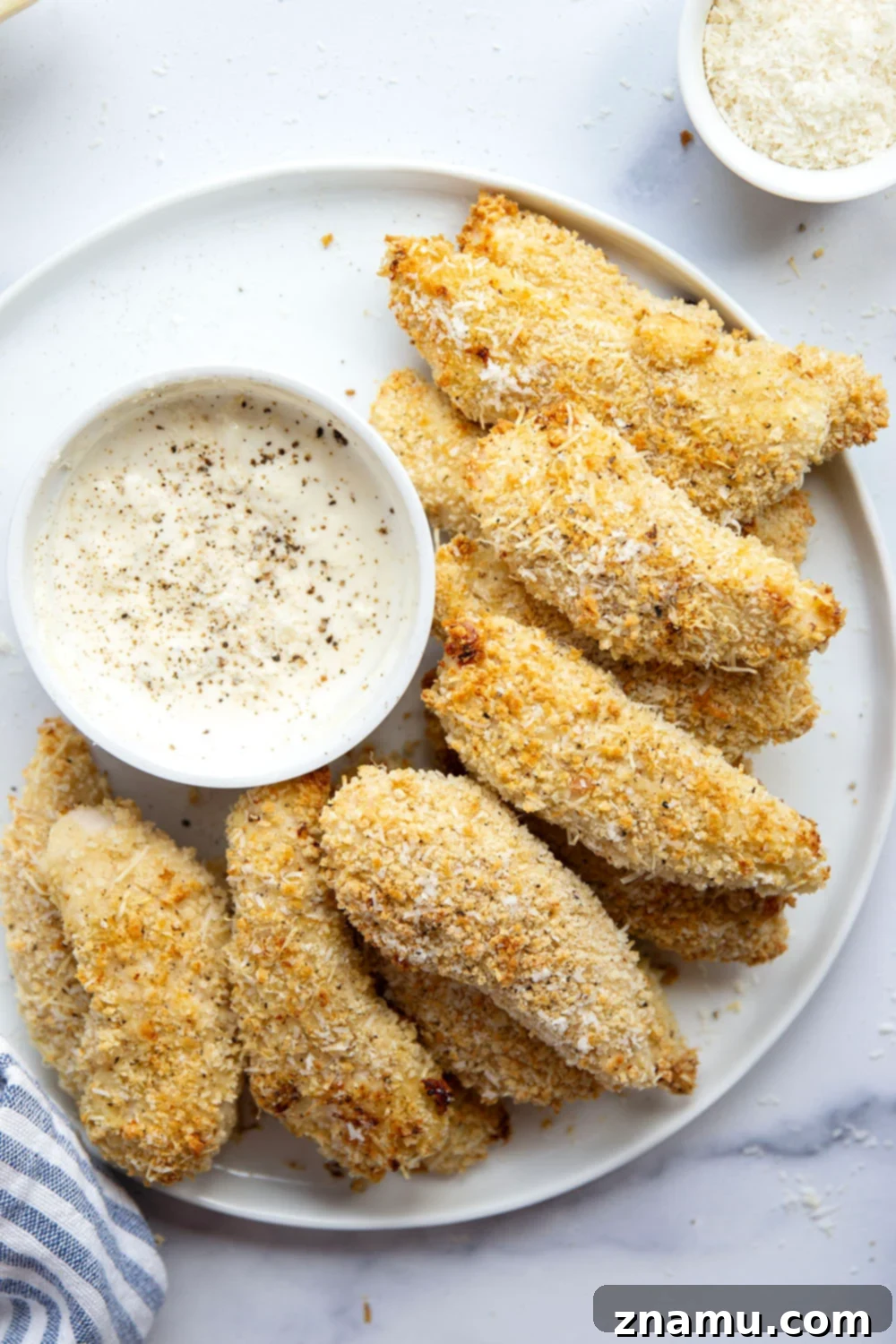 Delicious oven-baked chicken tenders coated in black pepper asiago breading