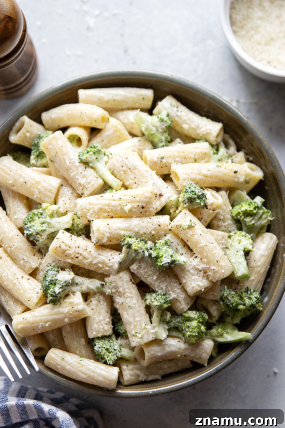 Velvety Parmesan Broccoli Pasta 4 Six basic ingredients for creamy Parmesan broccoli pasta laid out on a table