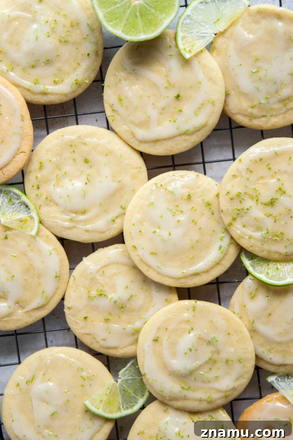 Zesty Lime Cream Cheese Tea Cakes 2 Delicious homemade lime tea cakes with creamy frosting on a white plate