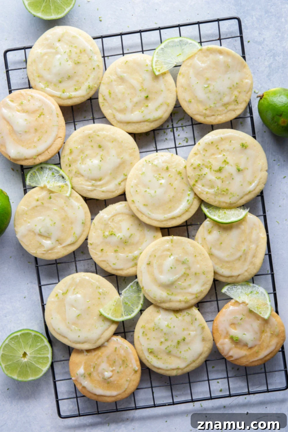 Zesty Lime Cream Cheese Tea Cakes 3 Close-up of fluffy lime tea cakes with creamy white glaze and fresh lime zest