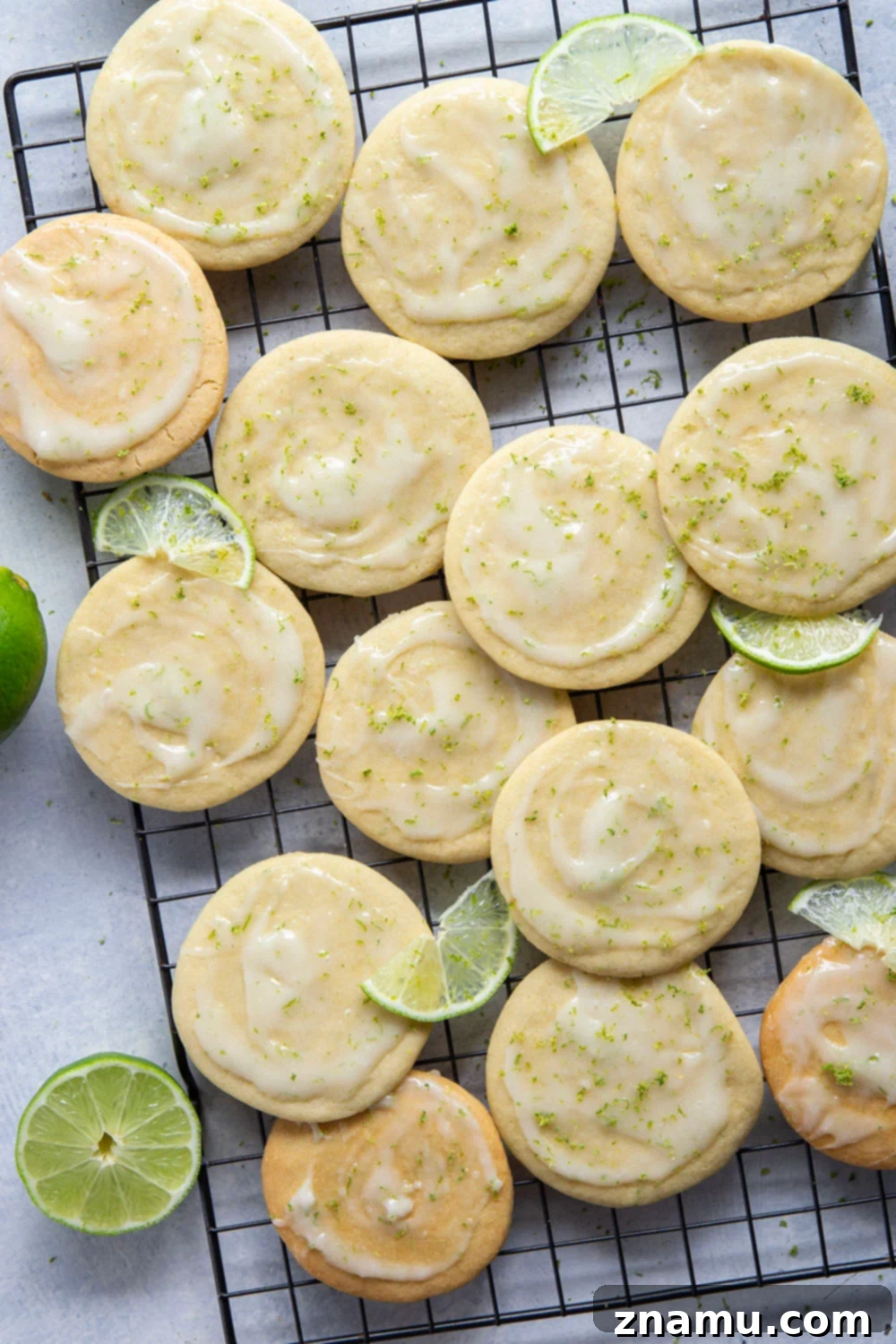 Zesty Lime Cream Cheese Tea Cakes 5 Ingredients for lime tea cakes laid out on a kitchen counter: butter, sugar, eggs, lime, flour, vanilla, baking soda, salt, cream cheese, powdered sugar, milk
