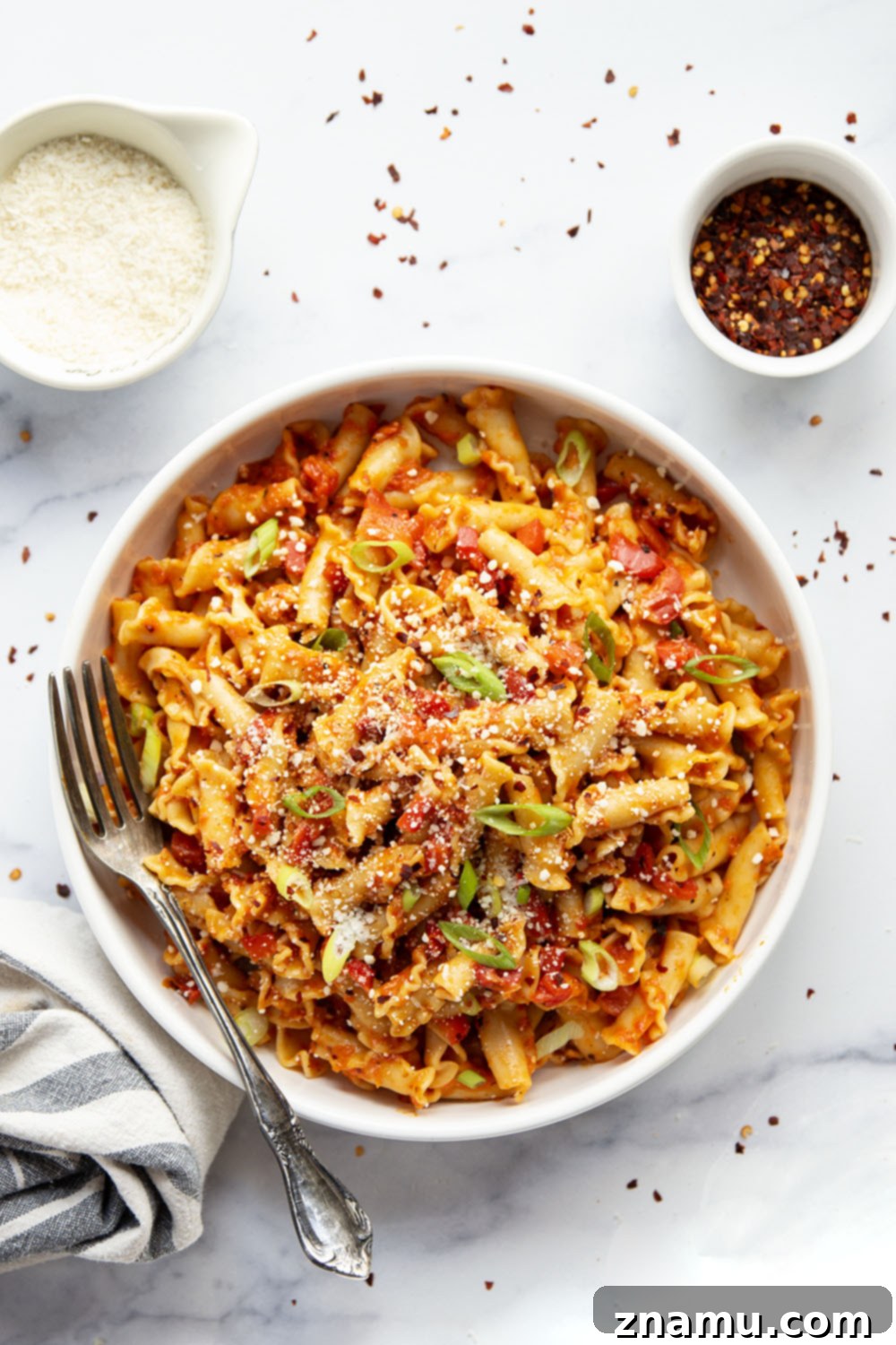 Fiery Roasted Red Pepper Pasta 2 Creamy and spicy roasted red pepper pasta, garnished with Parmesan and green onions.