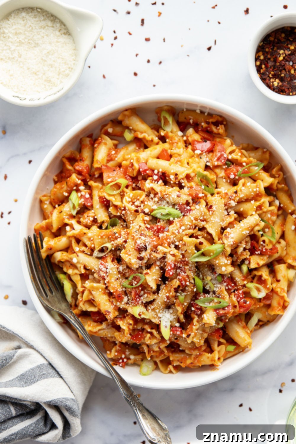 Fiery Roasted Red Pepper Pasta 6 Spicy roasted red pepper pasta in a serving bowl with fresh toppings.