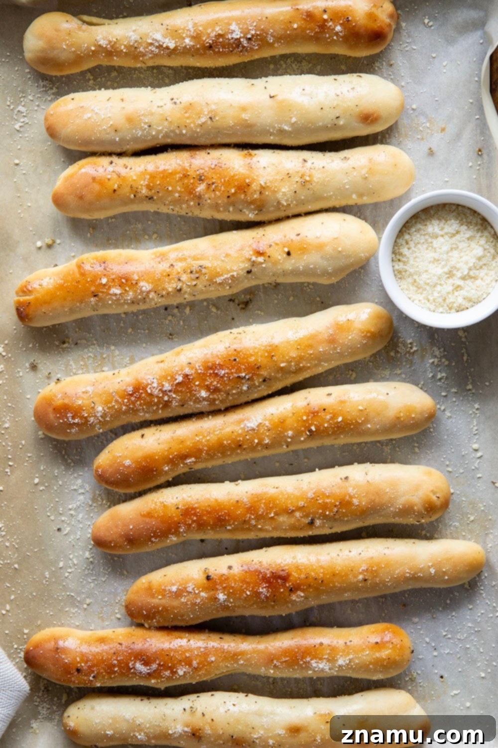 Irresistible Homemade Breadsticks 5 A baker's hands gently shaping homemade breadstick dough into ropes.
