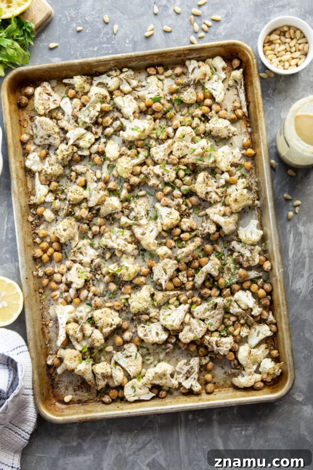 Za'atar Roasted Cauliflower & Chickpea Delight 3 Freshly roasted cauliflower florets and chickpeas seasoned with za'atar, showcasing a golden-brown crispness.