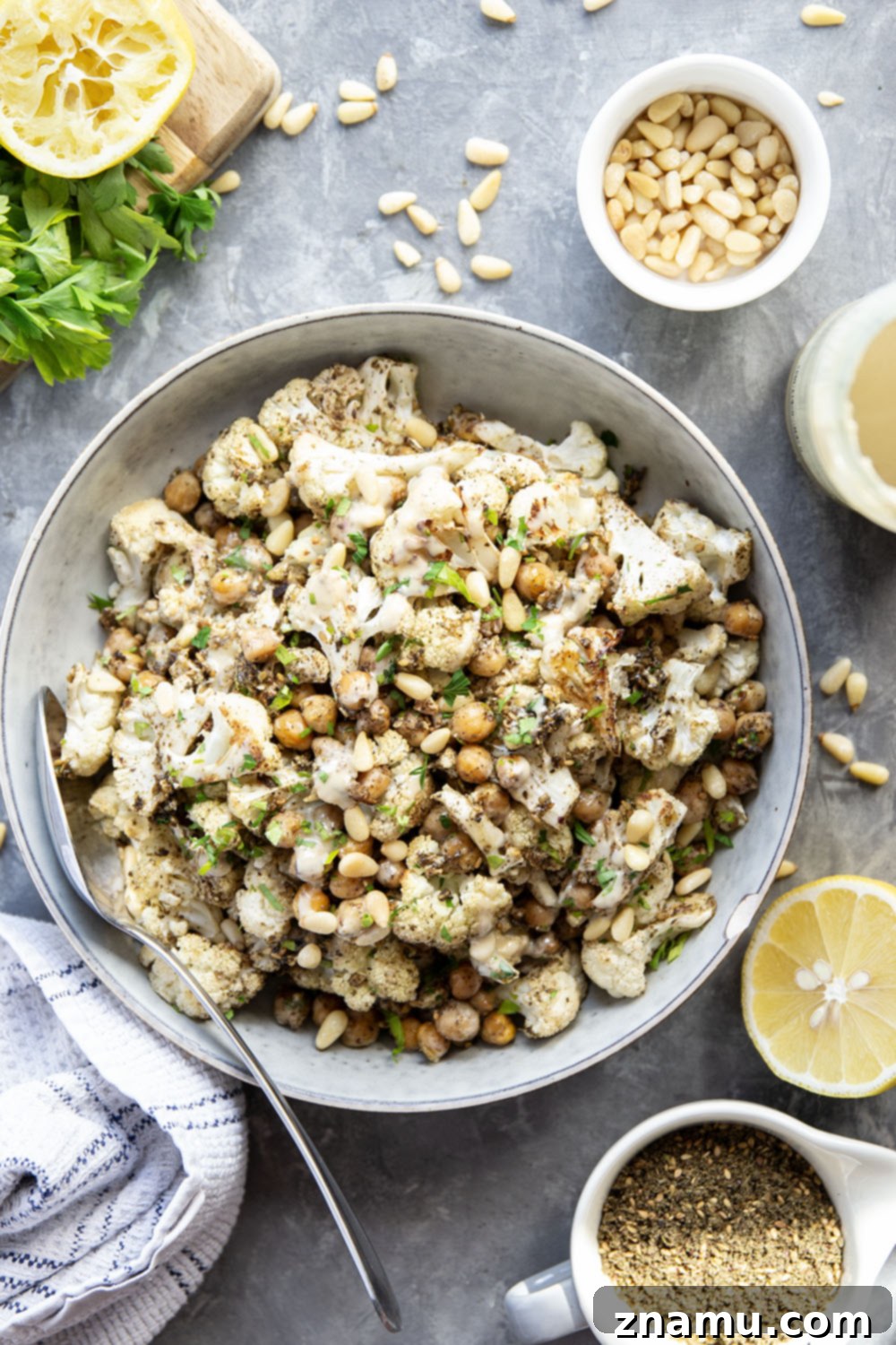 Za'atar Roasted Cauliflower & Chickpea Delight 6 A top-down view of a ready-to-eat serving of Za'atar Roasted Cauliflower and Chickpeas with a generous tahini swirl.
