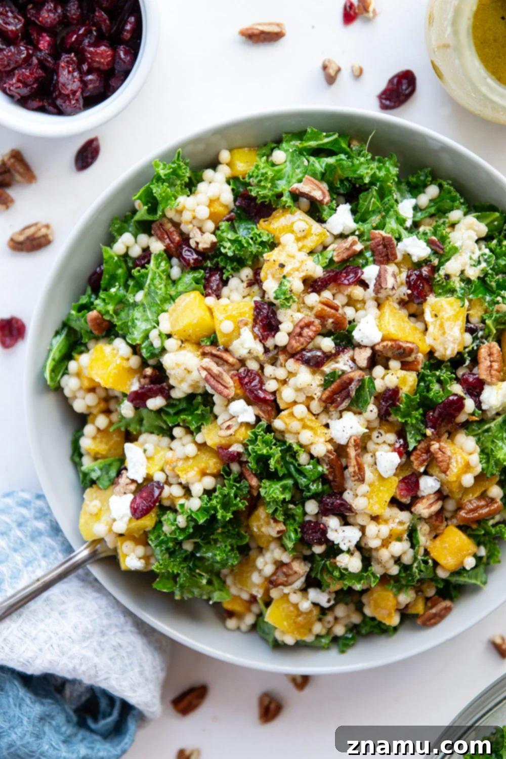 Vibrant Roasted Butternut Squash Couscous Salad 3 This butternut squash couscous salad features spice-roasted butternut squash, tender pearl couscous, and lots of fall ingredients all tossed in a honey Dijon dressing.