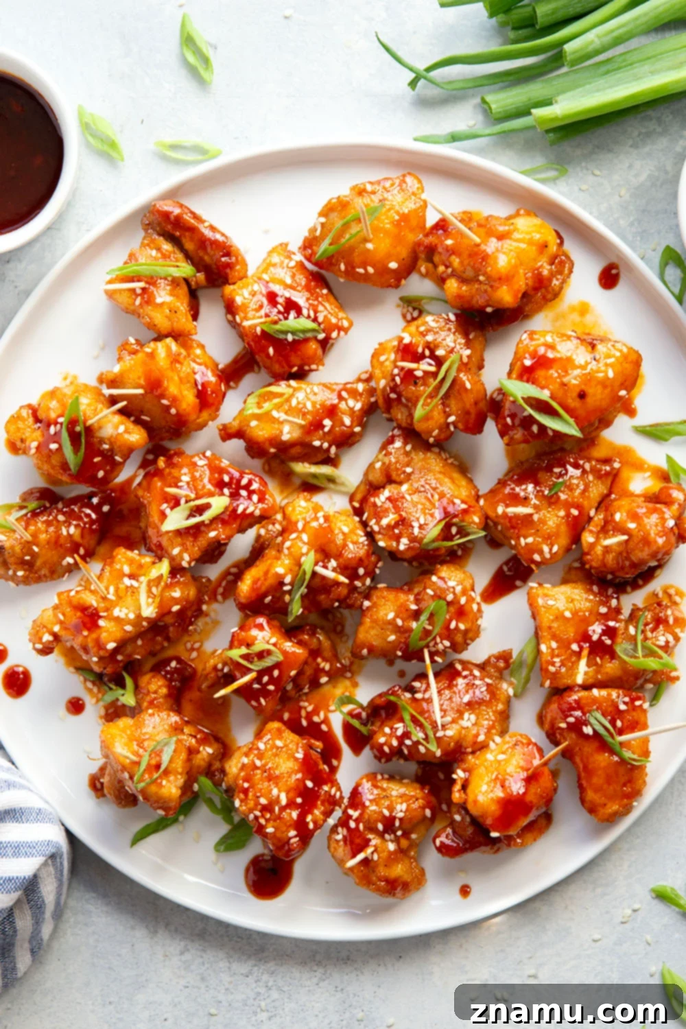 Gochujang Glazed Chicken Bites 2 Perfectly crispy pan-fried chicken bites tossed in a sweet and spicy gochujang sauce, served as an easy and flavor-packed appetizer.