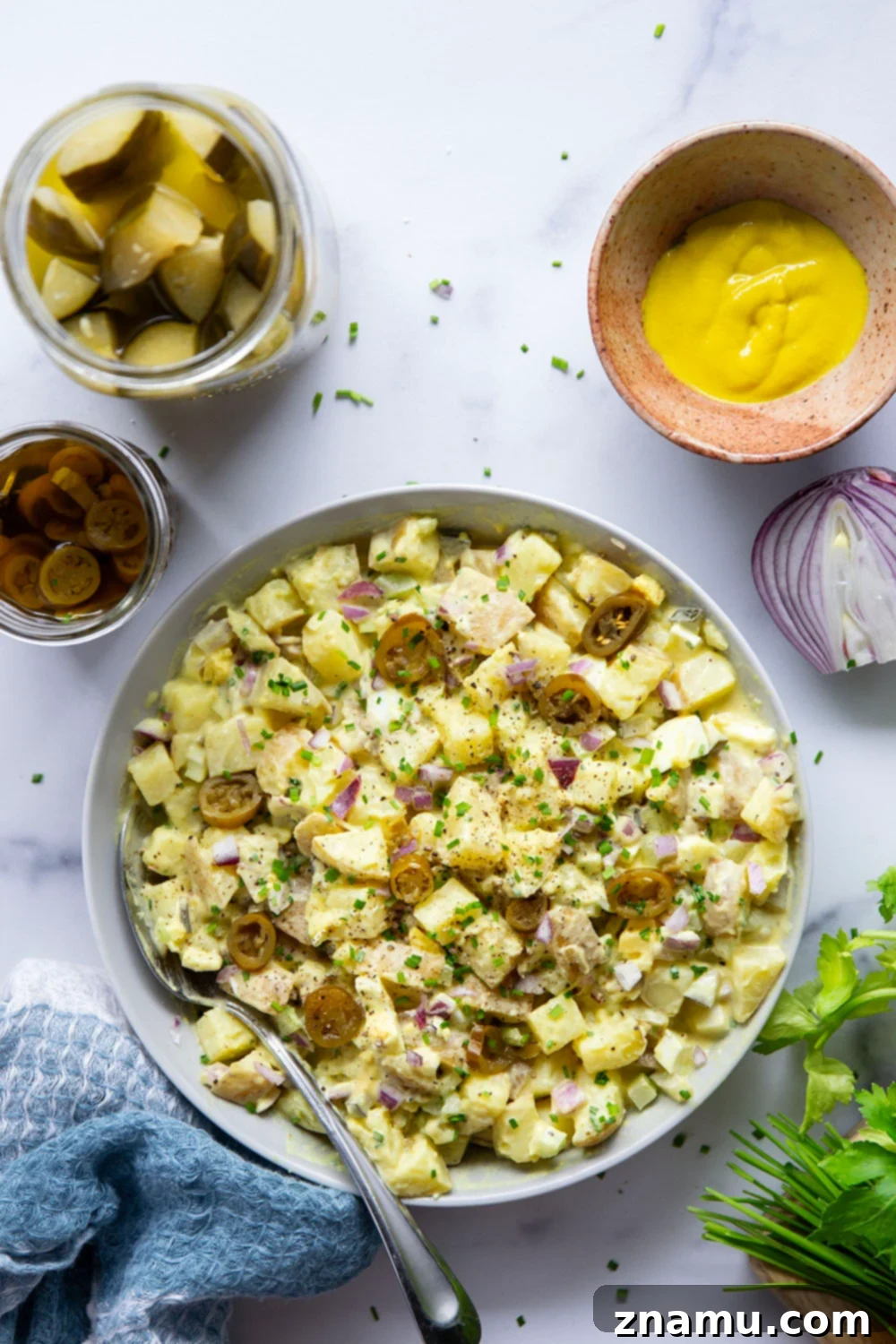 Authentic Texas Potato Salad 2 Texas potato salad features a tangy yellow mustard dressing coating tender potatoes with lots of pickled jalapenos for a kick of heat.