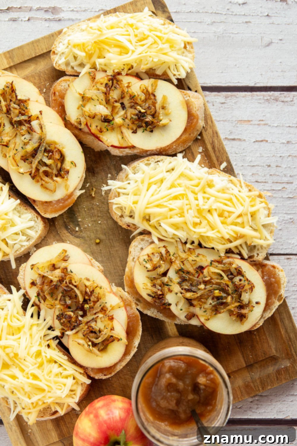 Stacked gourmet apple butter and caramelized onion grilled cheese sandwiches, showcasing the layers of deliciousness.