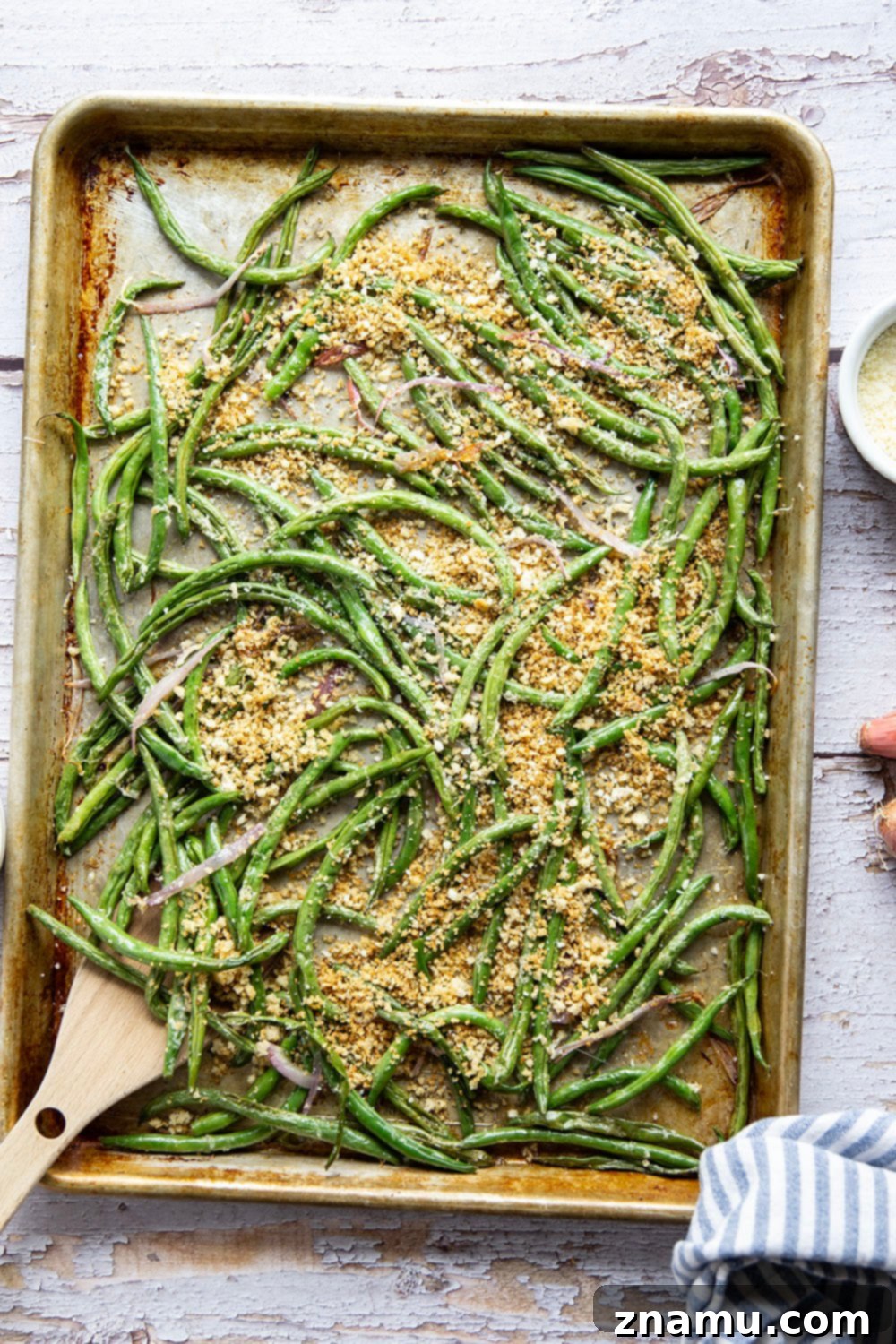 Golden Green Beans with Nutty Butter and Garlic Crunch 6 A large serving bowl filled with browned butter green beans and garlic breadcrumbs, ready to be enjoyed.