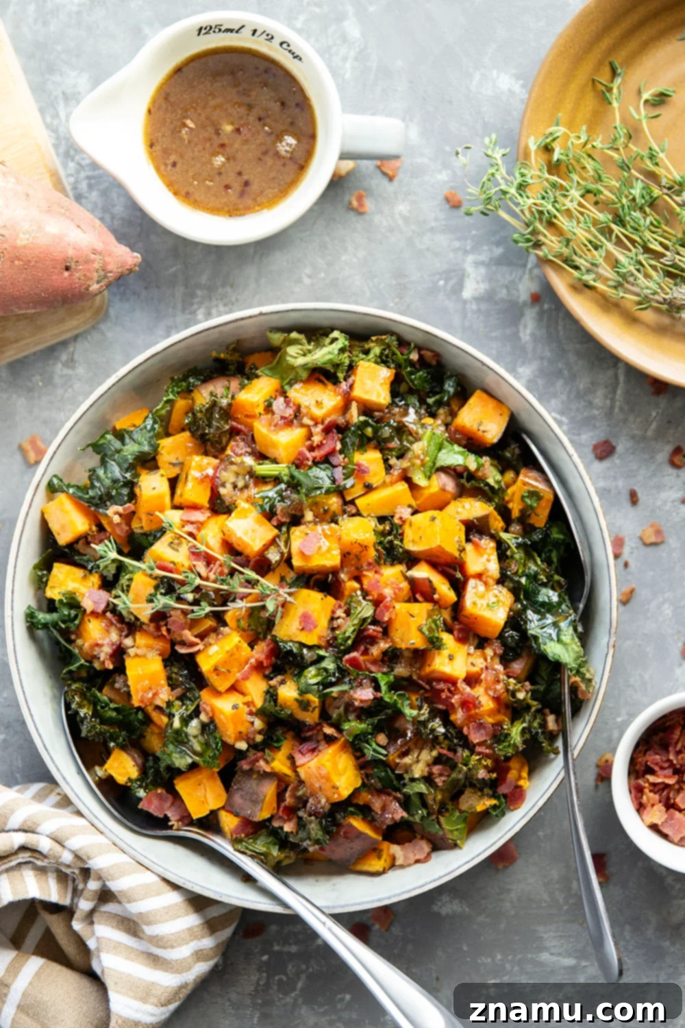 Hearty Sweet Potato Medley with Savory Bacon Infusion 6 Serving bowl of warm sweet potato and kale salad with bacon