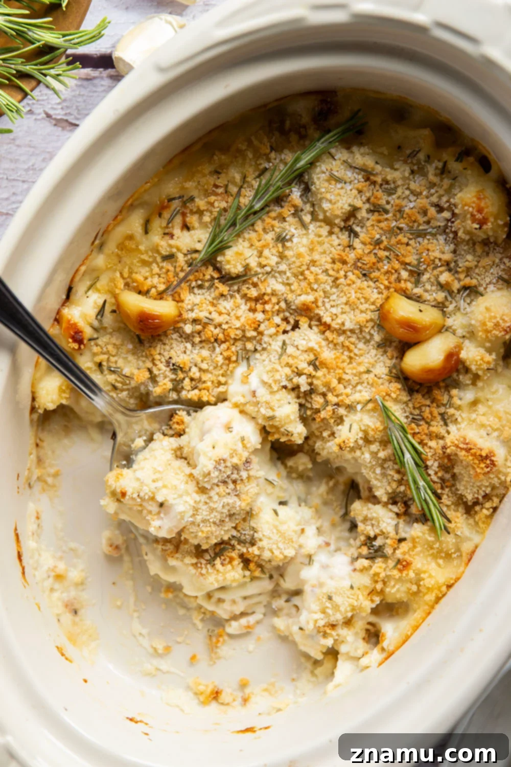 Garlicky Cheesy Cauliflower Gratin 5 Roasted garlic cloves emerging from their skins, ready to be mashed for the cauliflower au gratin.