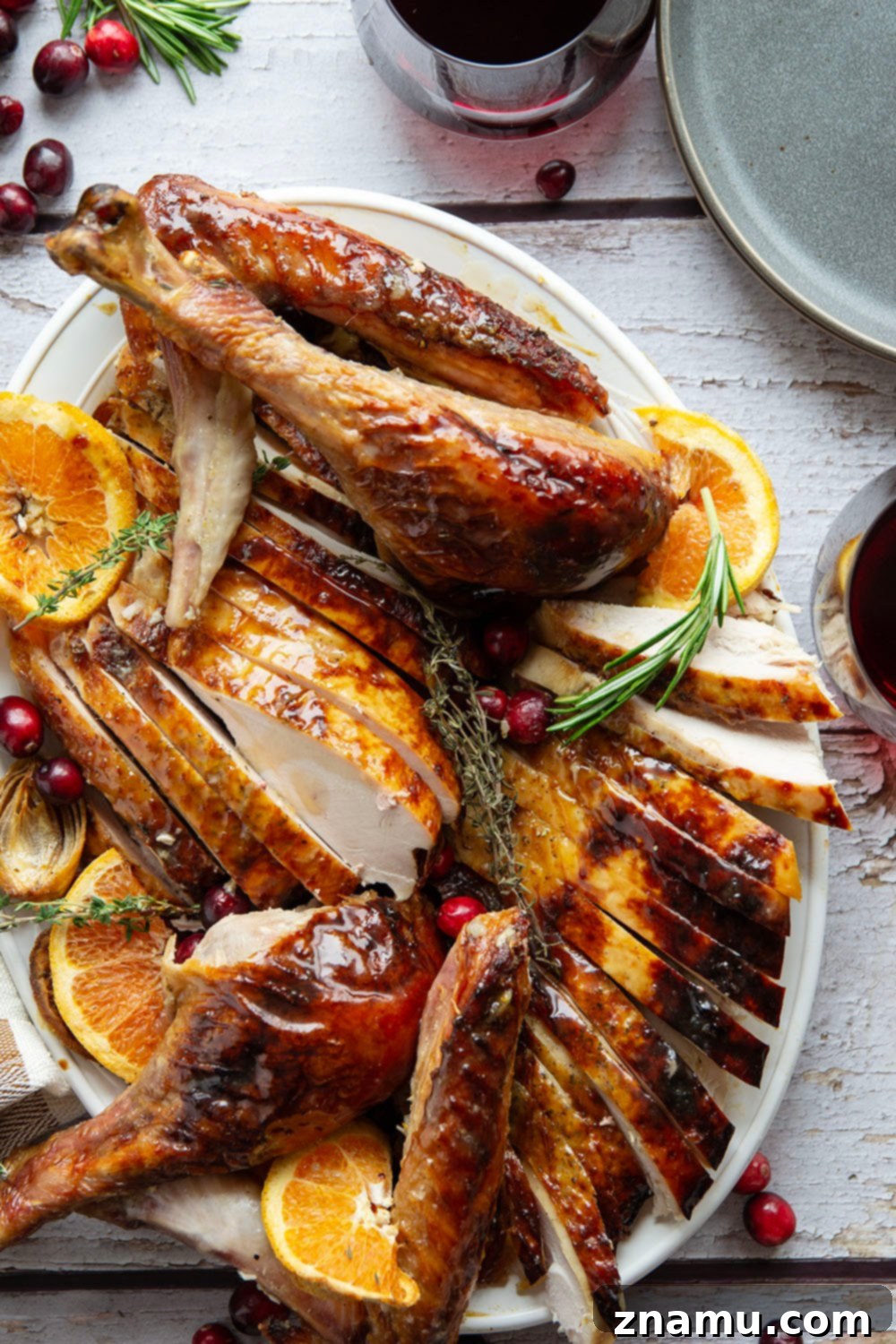 Golden Maple Turkey Roast 6 A close-up of a carved slice of Maple Glazed Turkey, showcasing the juicy, tender meat. The golden-brown, crispy skin with a hint of glaze is visible, emphasizing the perfect texture achieved without brining.