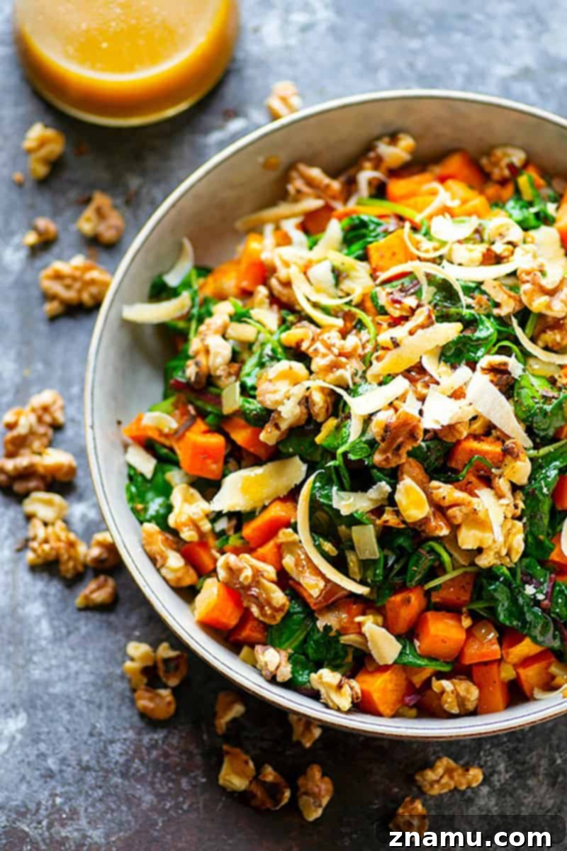 Your Thanksgiving Feast Roadmap 18 A vibrant Warm Sweet Potato Kale Salad, dressed with a creamy tahini dressing, served in a rustic bowl.