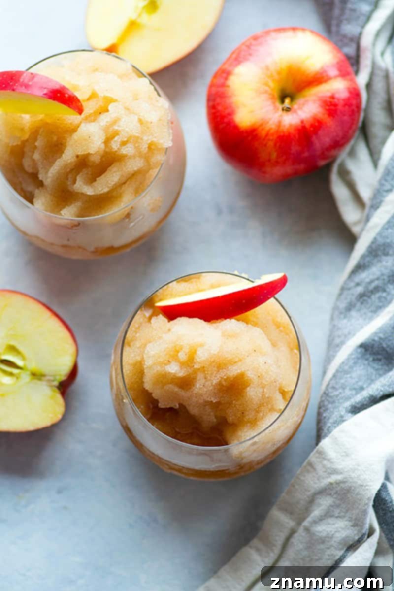 Your Thanksgiving Feast Roadmap 5 Two glasses of Apple Cider Bourbon Slushies, garnished with cinnamon sticks and apple slices, perfect for a fall celebration.
