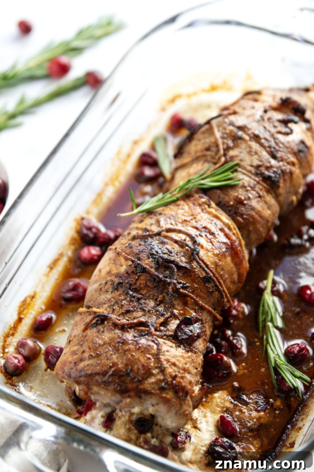 Goat Cheese Cranberry Stuffed Pork Loin tied with kitchen twine, ready for searing