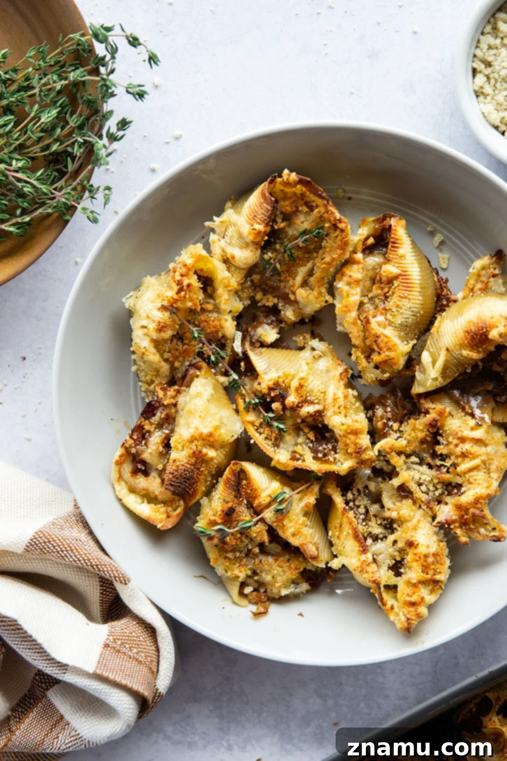 Caramelized Onion Gruyère Stuffed Shells 2 French Onion Stuffed Shells: Tender caramelized onions, rich broth, gooey cheese, and crispy breadcrumbs for a delicious twist on classic soup.