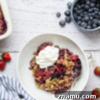 Tangy rhubarb and berries in a crisp, a perfect combination for a summer dessert.