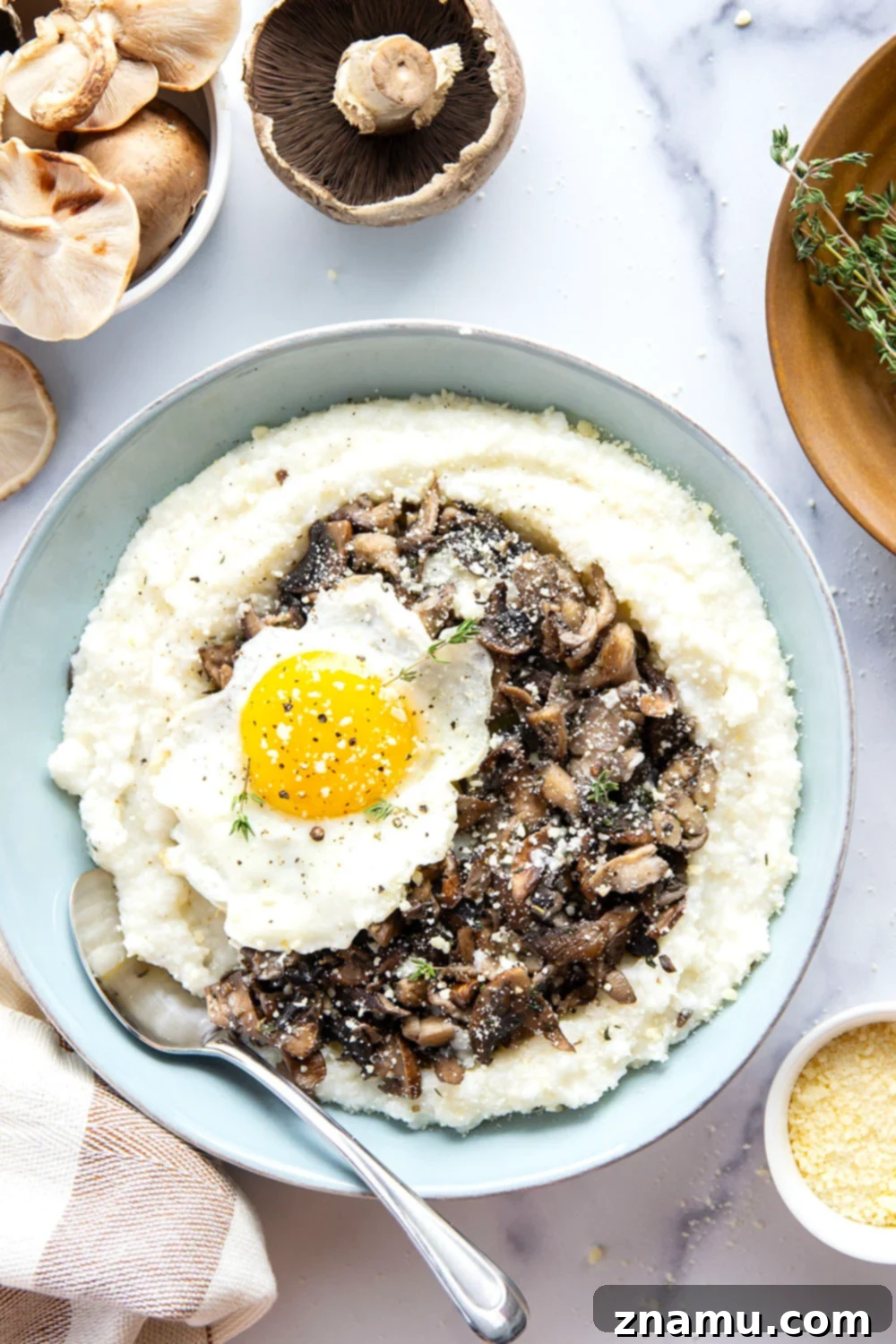 Creamy grits topped with flavorful sautéed wild mushrooms, a fried egg, and fresh asiago cheese.