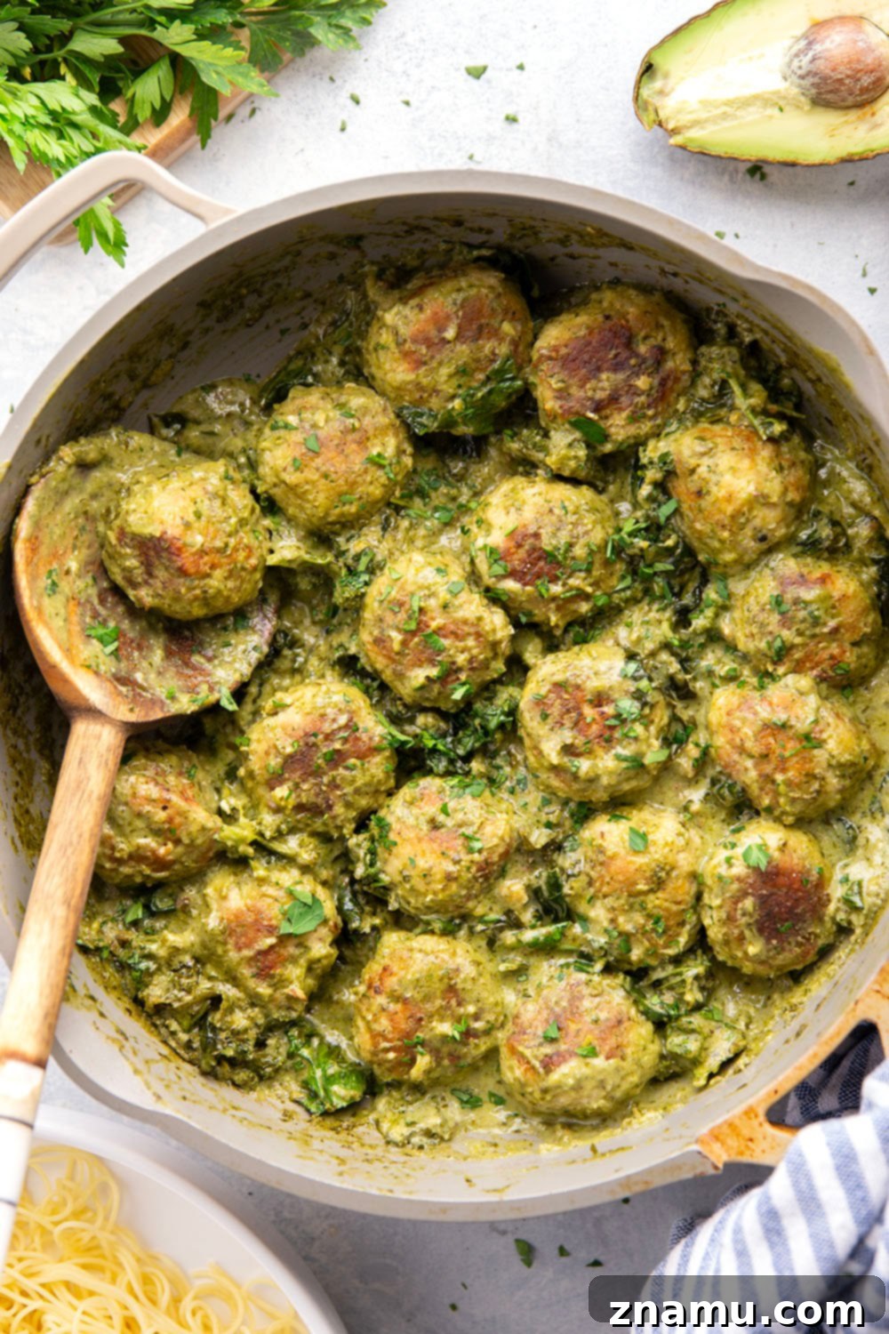 Creamy Green Goddess Chicken Meatballs 4 Close-up of green goddess chicken meatballs with fresh herbs and sauce.
