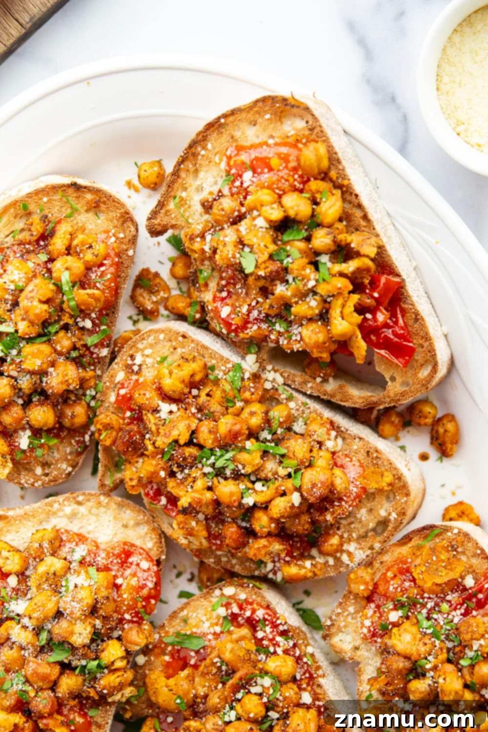 Crispy smashed chickpeas and a simple sweet cherry tomato compote are the perfect pairing in this smashed chickpea toast! Serve it for lunch or mini-sized for an appetizer.