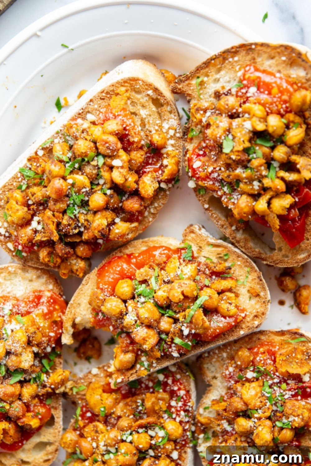 Crispy smashed chickpeas and a simple sweet cherry tomato compote are the perfect pairing in this smashed chickpea toast! Serve it for lunch or mini-sized for an appetizer.