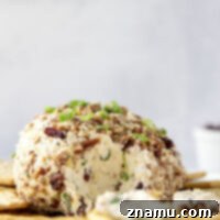 This smoked cranberry cheese ball is packed with tangy cranberries, smoky shredded cheddar cheese, lots of green onions, and rolled in crunchy toasted pecans. The easiest holiday appetizer you'll ever make!