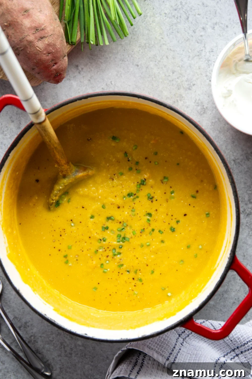 Golden Sweet Potato Leek Bliss 3 Close-up shot of the vibrant orange color and smooth texture of creamy sweet potato leek soup.
