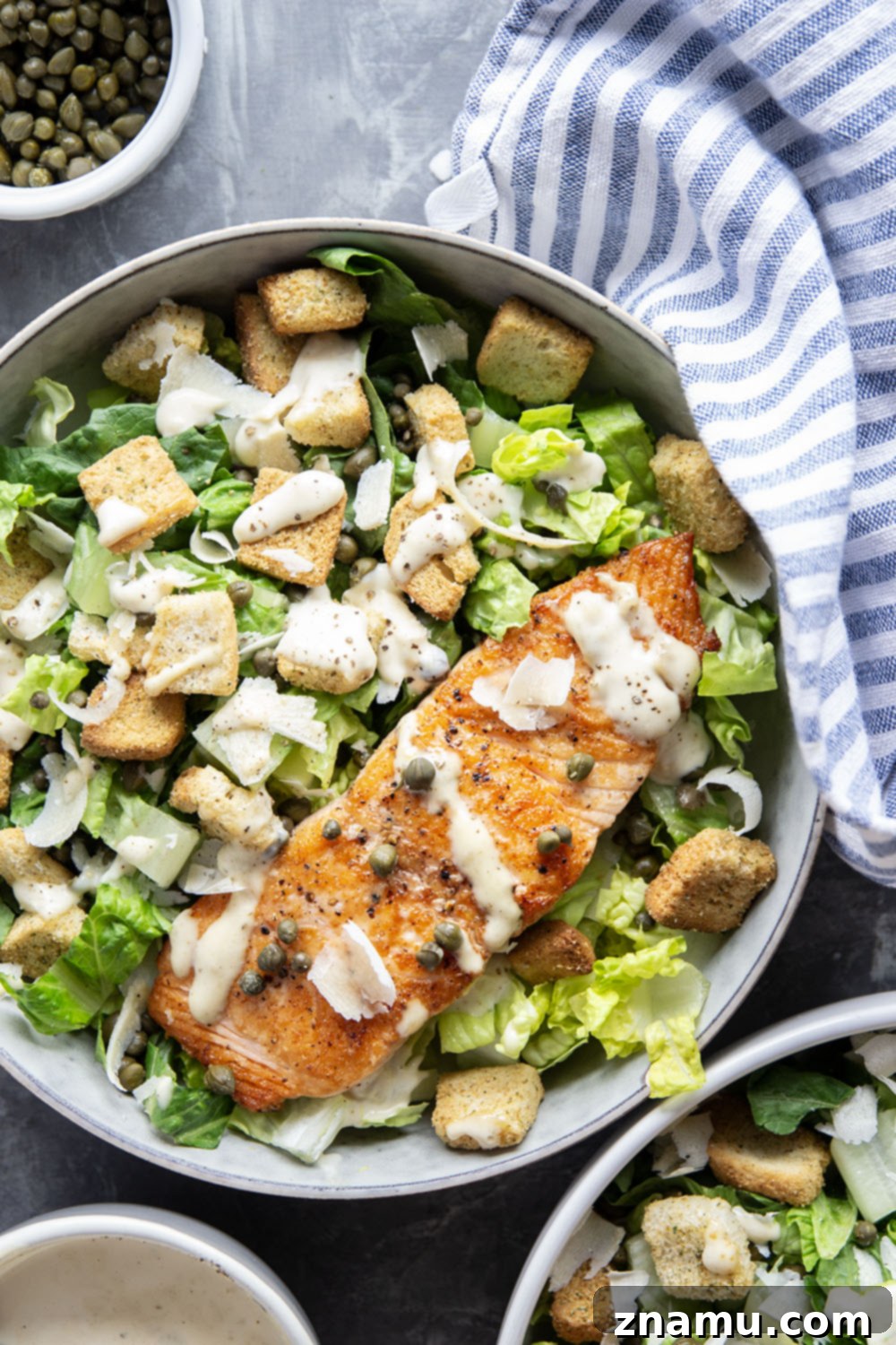 Golden-Crisp Salmon Caesar with Slow-Roasted Garlic Dressing 5 Buttery seared salmon fillets are the perfect meat pairing in this protein-packed seared salmon Caesar salad that features a creamy roasted garlic dressing on top.