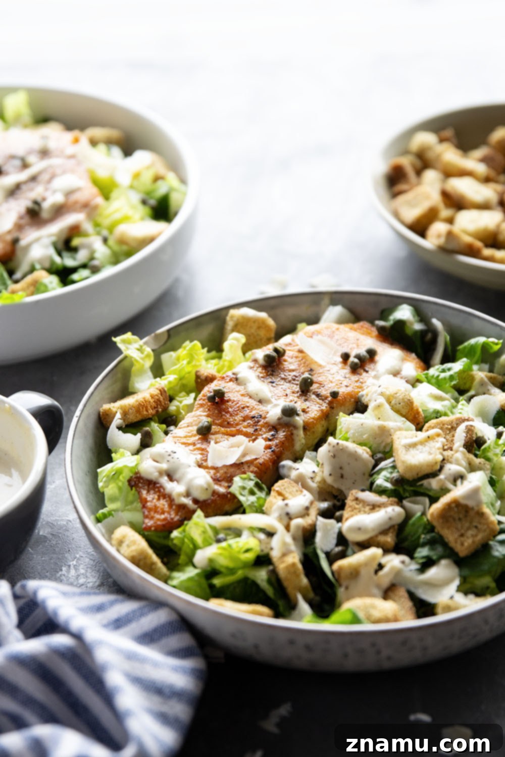 Golden-Crisp Salmon Caesar with Slow-Roasted Garlic Dressing 6 Buttery seared salmon fillets are the perfect meat pairing in this protein-packed seared salmon Caesar salad that features a creamy roasted garlic dressing on top.