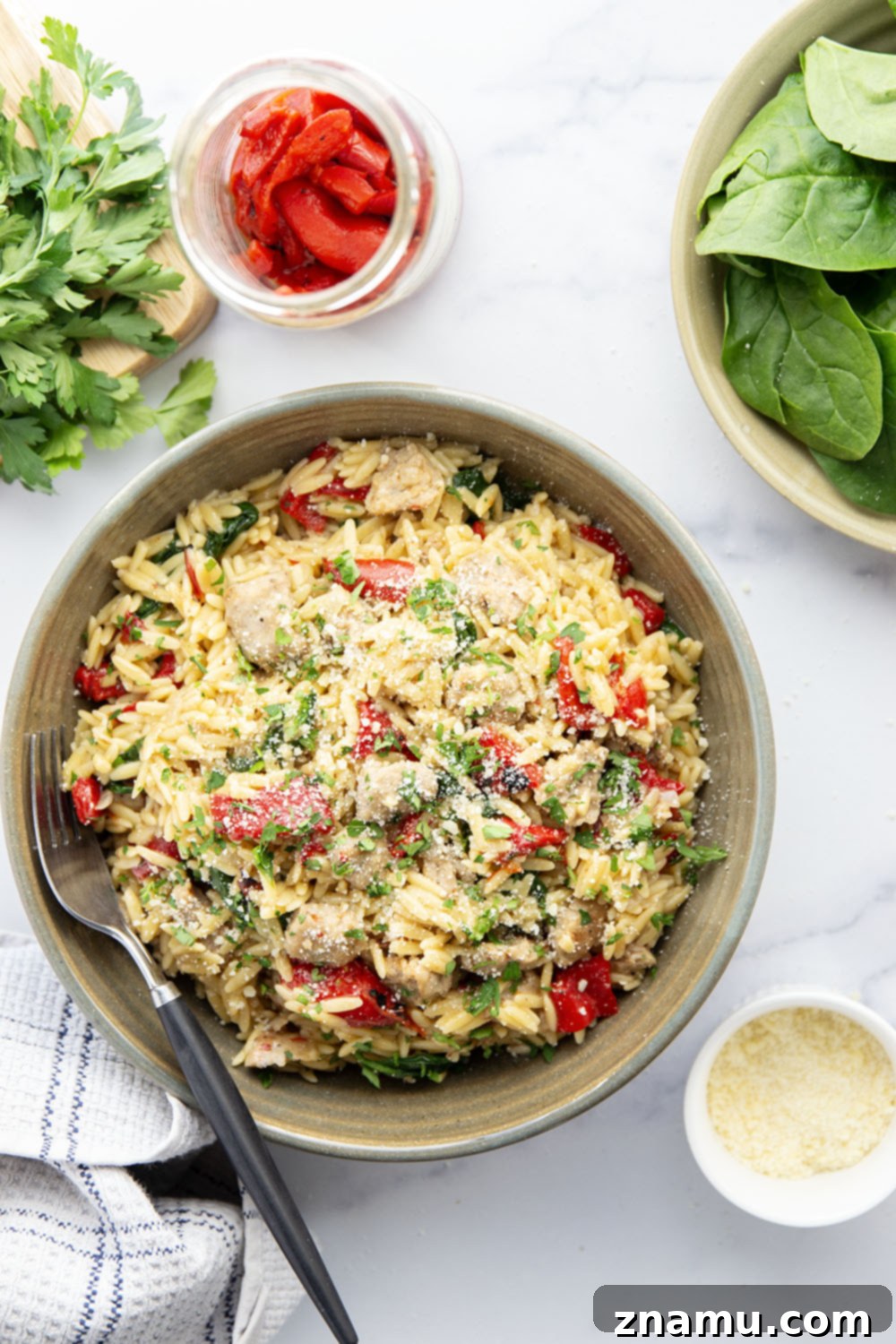 Easy One Pot Chicken Sausage Orzo 3 Overhead shot of a full pot of steaming One Pot Chicken Sausage Orzo, rich with chicken sausage pieces, red peppers, and green spinach, ready to be served.