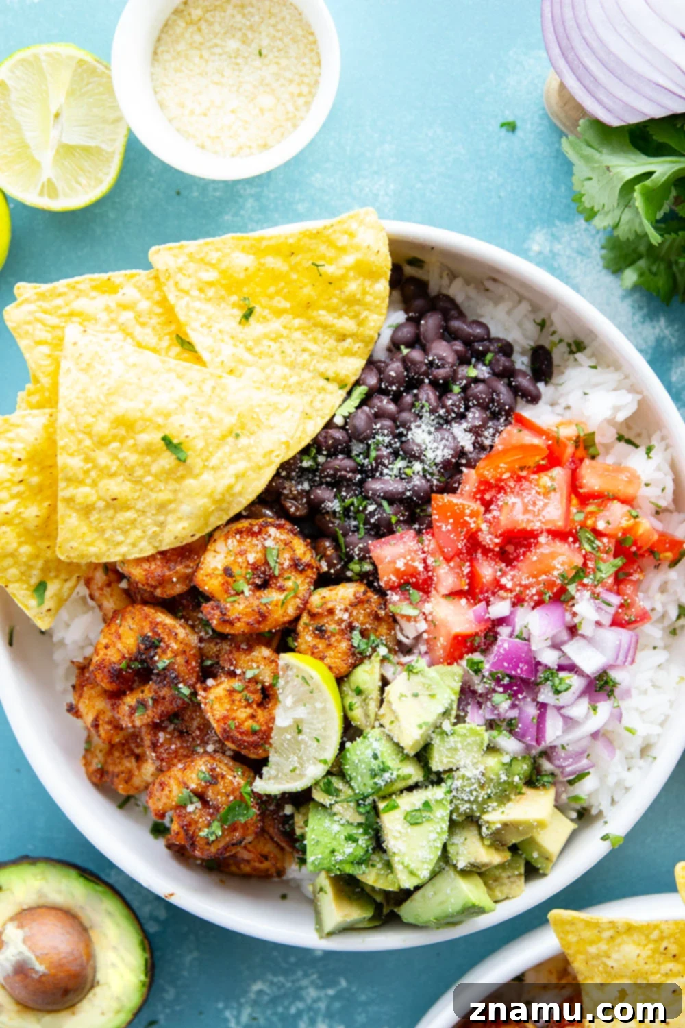 Juicy blackened shrimp is an incredible protein twist in these colorful blackened shrimp taco bowls! Easy to meal prep ahead of time and you can customize them with your favorite toppings.