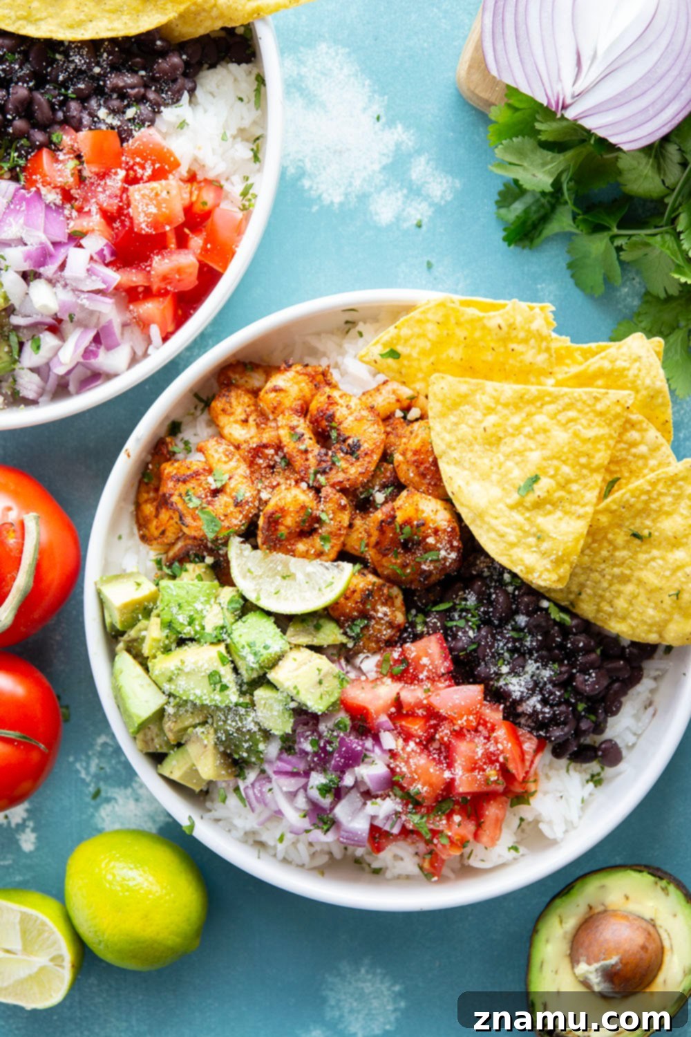 Juicy blackened shrimp is an incredible protein twist in these colorful blackened shrimp taco bowls! Easy to meal prep ahead of time and you can customize them with your favorite toppings.