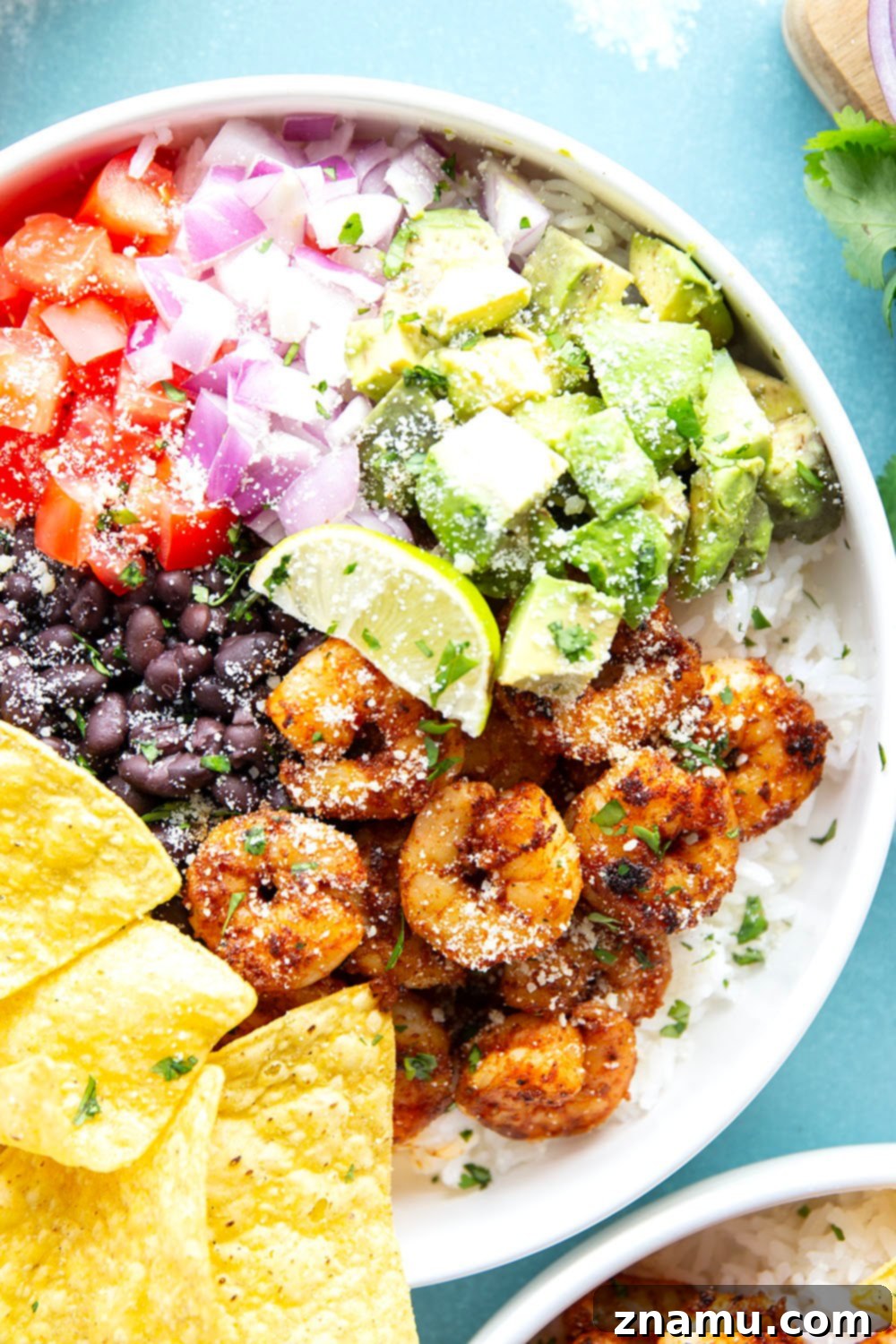 Juicy blackened shrimp is an incredible protein twist in these colorful blackened shrimp taco bowls! Easy to meal prep ahead of time and you can customize them with your favorite toppings.