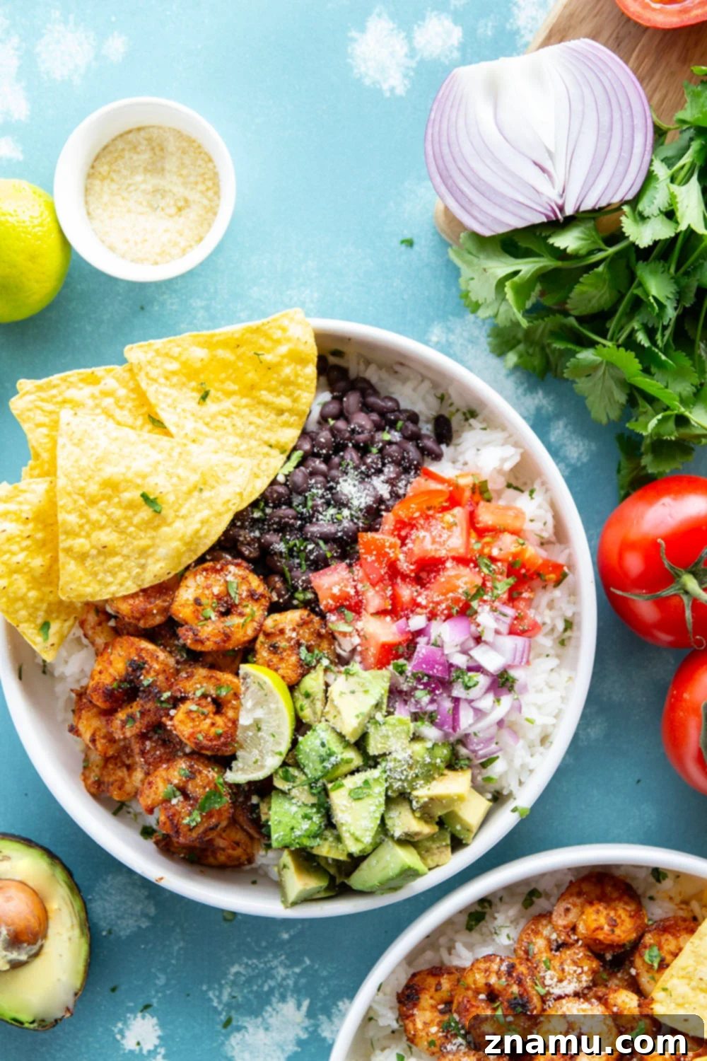 Juicy blackened shrimp is an incredible protein twist in these colorful blackened shrimp taco bowls! Easy to meal prep ahead of time and you can customize them with your favorite toppings.