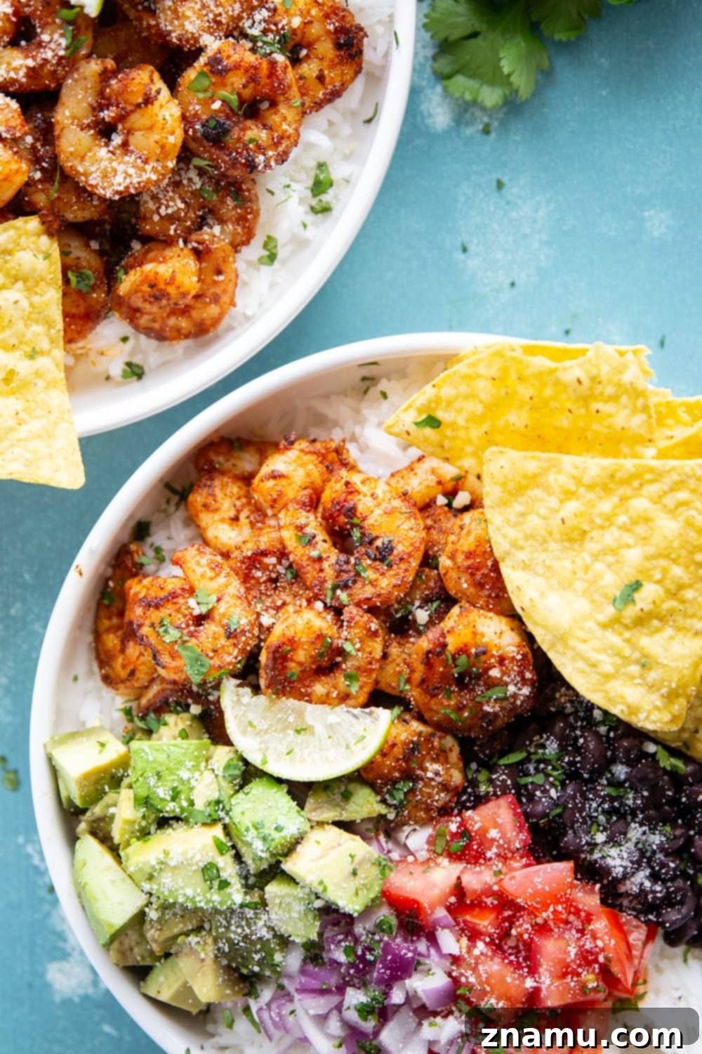 Juicy blackened shrimp is an incredible protein twist in these colorful blackened shrimp taco bowls! Easy to meal prep ahead of time and you can customize them with your favorite toppings.