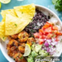 Juicy blackened shrimp is an incredible protein twist in these colorful blackened shrimp taco bowls! Easy to meal prep ahead of time and you can customize them with your favorite toppings.