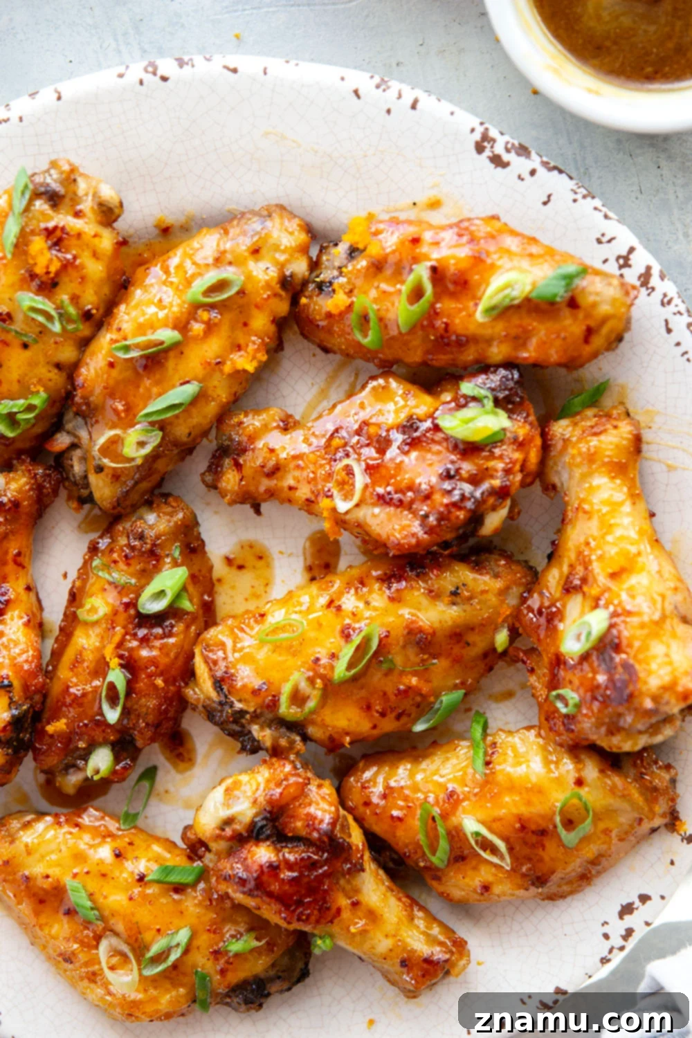 Sweet Heat Orange Wings 5 Oven baked to crispy perfection and tossed in a sweet and spicy orange hot honey sauce, these hot honey chicken wings are the ultimate game day appetizer!