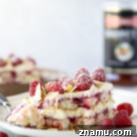 Velvet Amaretto Raspberry Tiramisu 8 This amaretto raspberry tiramisu features layers of coffee and amaretto-soaked ladyfingers, a tangy raspberry sauce, and mounds of fluffy mascarpone cream. A delightful fruity twist on the classic!