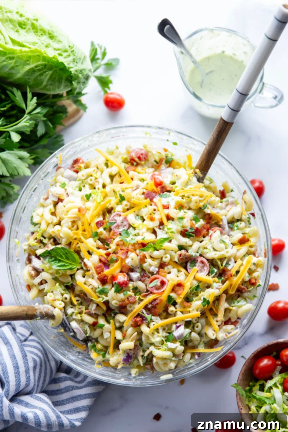 This BLT macaroni salad is packed with crispy bacon, shredded lettuce, juicy tomatoes, lots of shredded cheddar, and tossed in a perfectly creamy homemade herb ranch dressing.