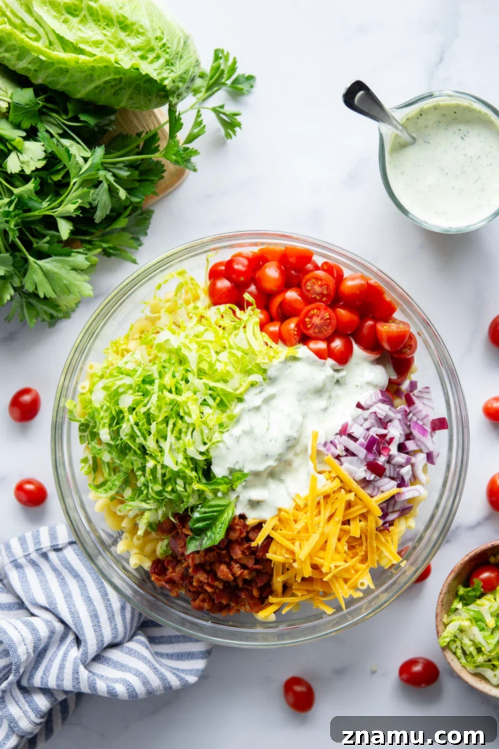 This BLT macaroni salad is packed with crispy bacon, shredded lettuce, juicy tomatoes, lots of shredded cheddar, and tossed in a perfectly creamy homemade herb ranch dressing.