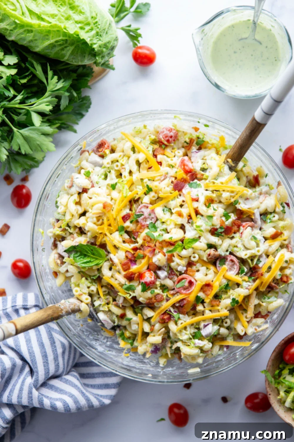 This BLT macaroni salad is packed with crispy bacon, shredded lettuce, juicy tomatoes, lots of shredded cheddar, and tossed in a perfectly creamy homemade herb ranch dressing.
