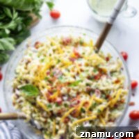 This BLT macaroni salad is packed with crispy bacon, shredded lettuce, juicy tomatoes, lots of shredded cheddar, and tossed in a perfectly creamy homemade herb ranch dressing.