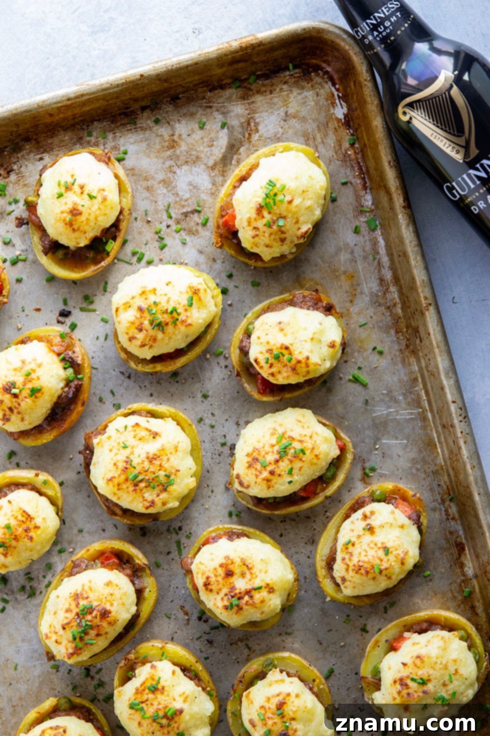 Guinness Shepherd's Pie Loaded Potato Skins 5 Roasted Yukon gold potatoes on a baking sheet, ready for scooping to create shepherd's pie potato skins.
