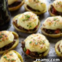 Guinness Shepherd’s Pie Potato Skins: Crispy potato skins filled with a savory Guinness-infused beef and vegetable mixture, topped with fluffy mashed potatoes.