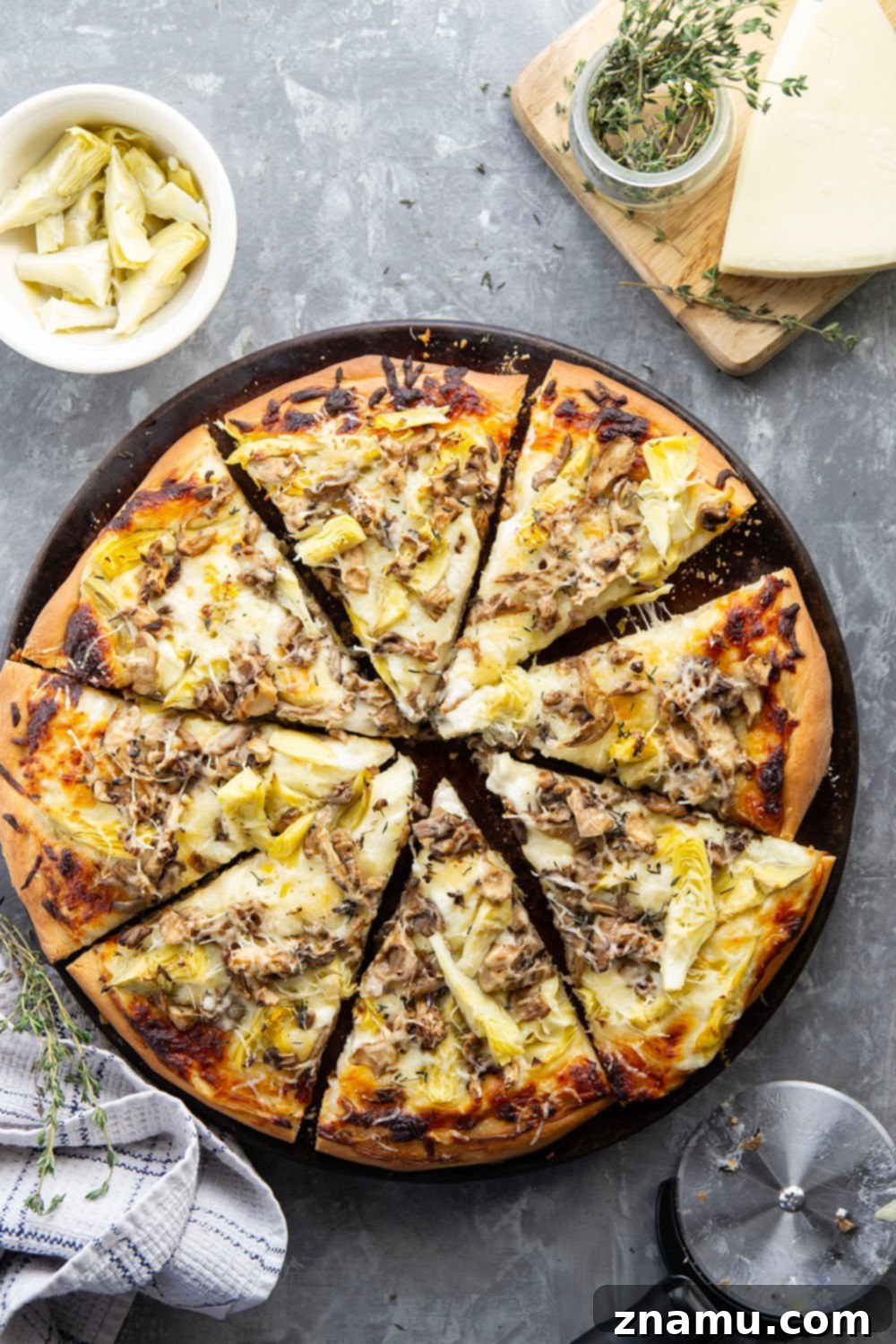 Gourmet Asiago Shiitake Mushroom Artichoke Pizza 3 This mushroom artichoke pizza features a creamy asiago alfredo sauce, buttery sauteed shiitake mushrooms, and lots of tender artichoke hearts.