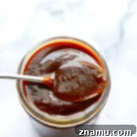 Homemade BBQ sauce in a jar, ready to be served or stored.