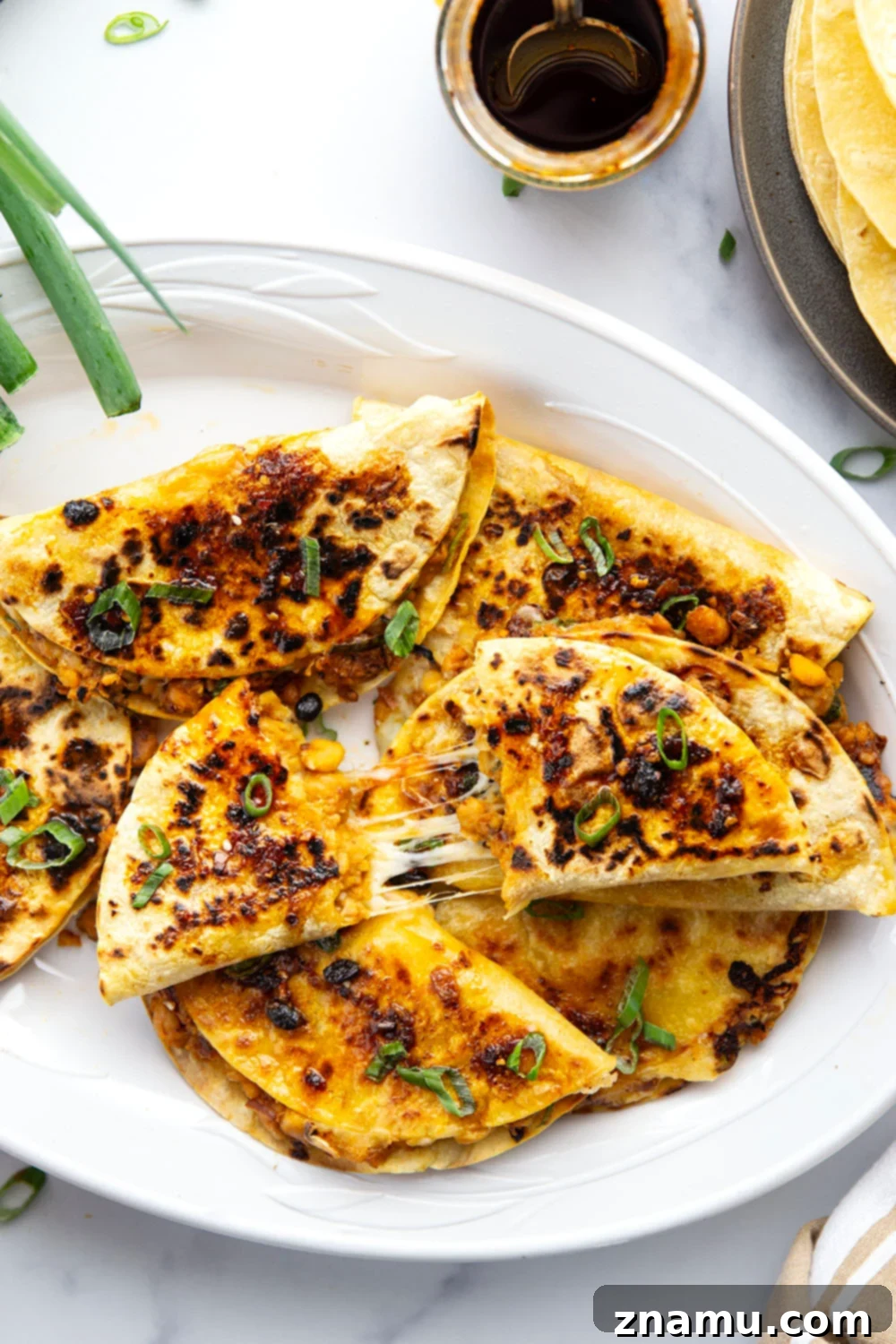 Golden Smashed Chickpea Tacos 2 These crispy chickpea tacos feature a smashed chickpea filling with two kinds of gooey cheese melted inside and lots of spicy chili crisp.